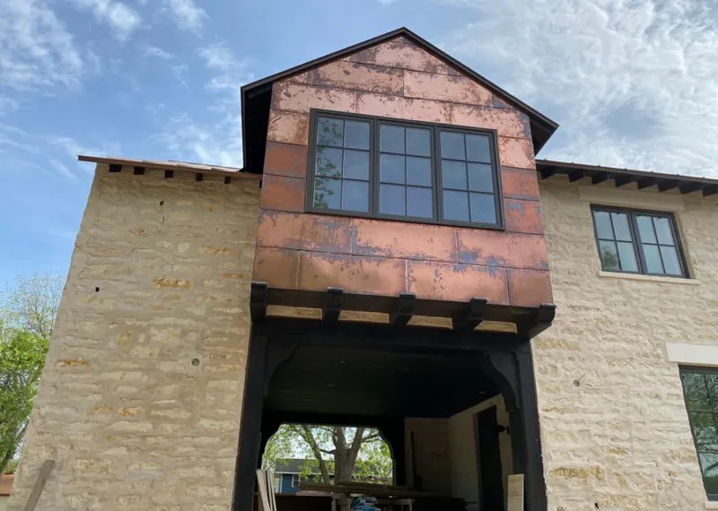 Copper metal panel facade on a stone building for Metal Roof Coating in Johnston